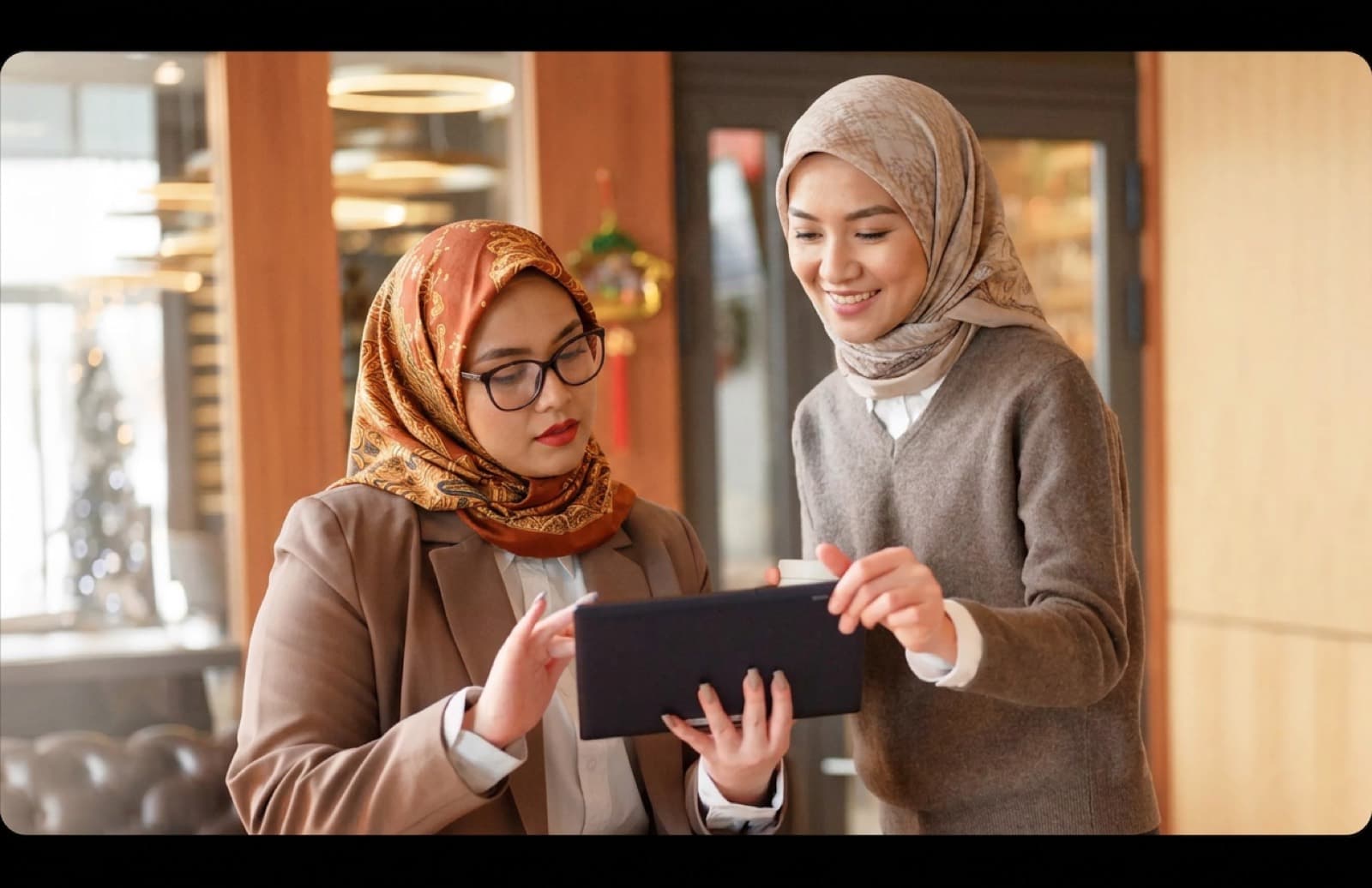 Two professionals reviewing a tablet together